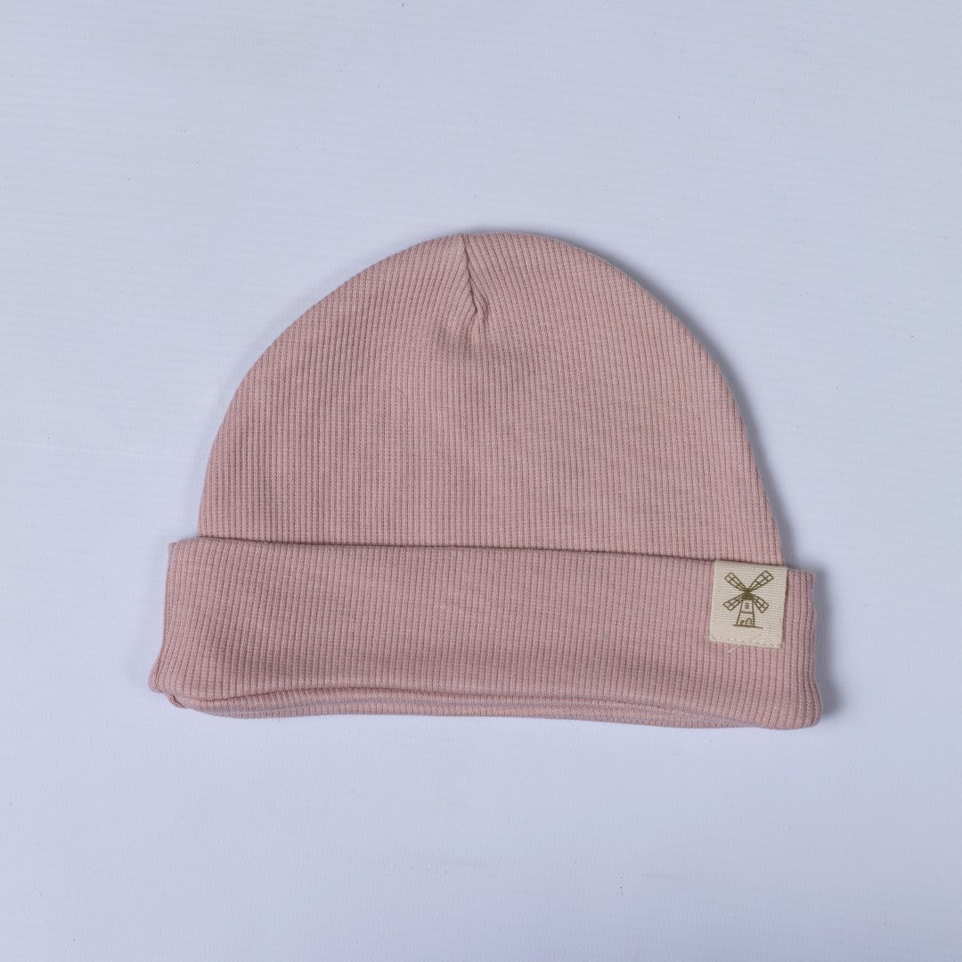 Baby pink children's beanie hat with rolled hem and hem tag