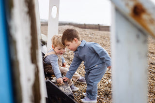 Aneby models playing with stones on the beach