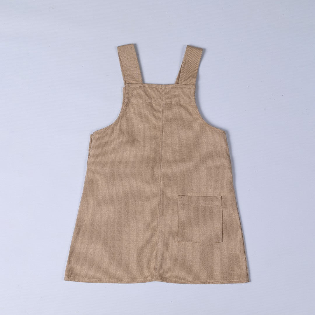 Rear view of oat beige dungaree dress with patch pocket and centre back seam