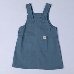 Slate blue dungaree dress with front patch pocket and hem tag