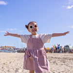 Girl On Beach Wearing Button Front Pink Dress