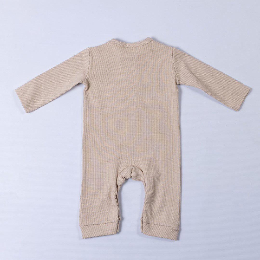 Rear view of long sleeve jersey rib jumpsuit in neutral oat