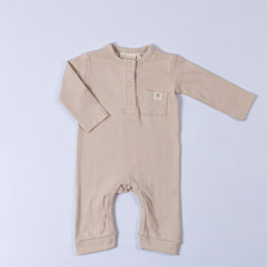 Aneby playsuit in beige featuring front placket and dyed to match poppers