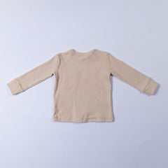 Rear image of neutral ecru long sleeve top with thick neck binding and cuffs