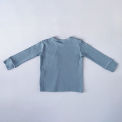 Rear image of slate blue long sleeve top with thick neck binding and cuffs