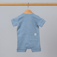 Back view of slate blue jersey short sleeve playsuit on wooden hanging rail