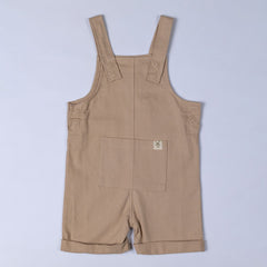 Oat beige dungaree shorts with a large front patch pocket with windmill hem tag