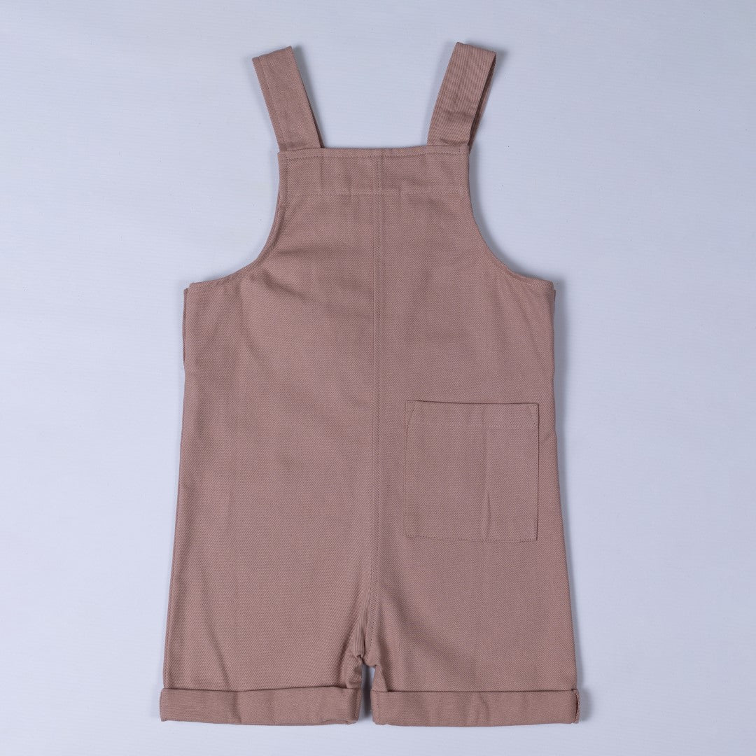 Back of pink Aneby dungaree shorts with shoulder straps and square patch pocket on back right leg