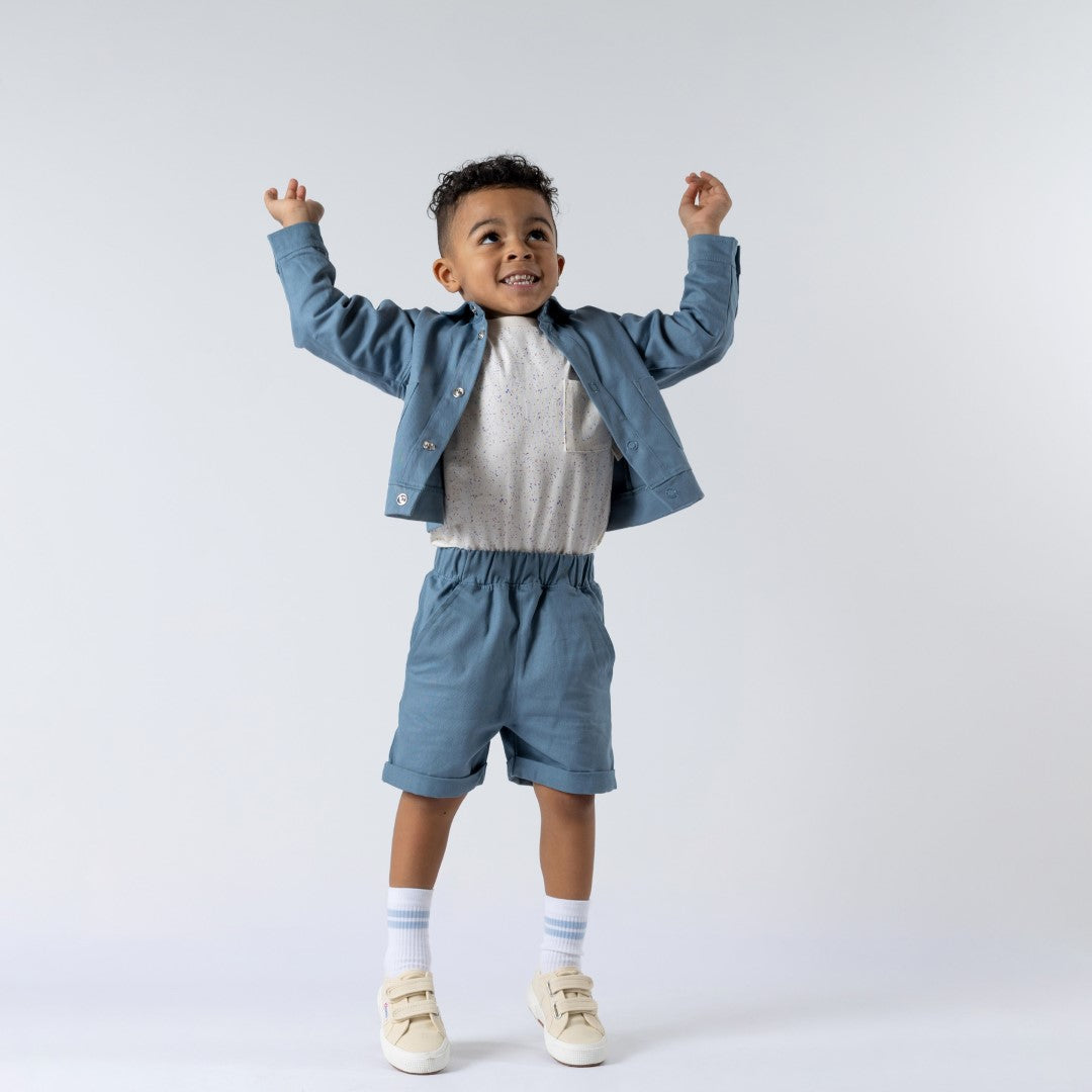 Boy modelling the speckled short-sleeved tee from Aneby with the boxy jacket to complete the look