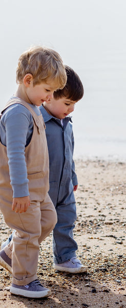 Two Boys Walking Along Beach