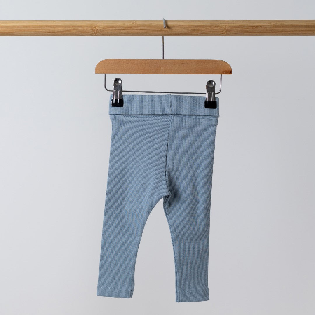 Back view of organic blue ribbed baby leggings, highlighting the ribbed texture and stitch work on the waistband. 