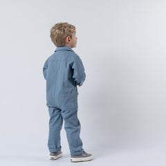 Side angle of a slate blue children's boilersuit, showcasing its comfortable design.