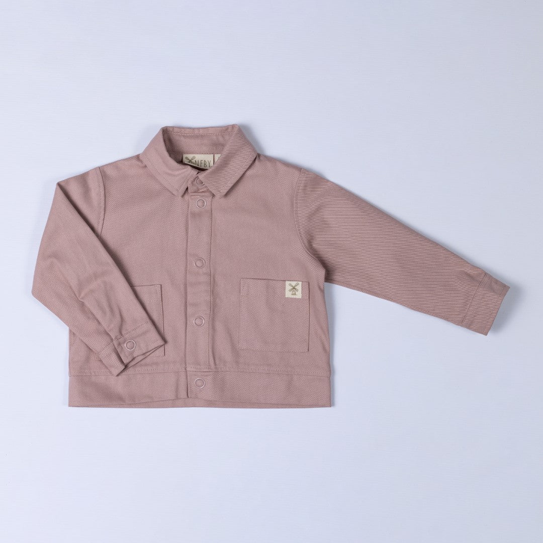 Front view of a dusty pink kids' organic cotton shacket, crafted from soft organic cotton twill.