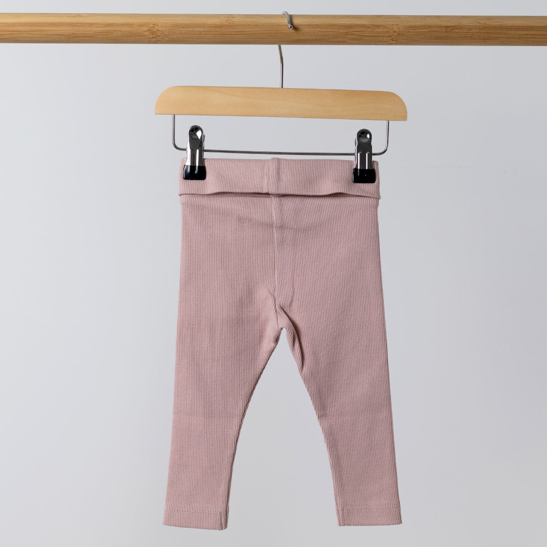 Back view of organic pink ribbed baby leggings, with visible ribbed details and high-quality stitch work.