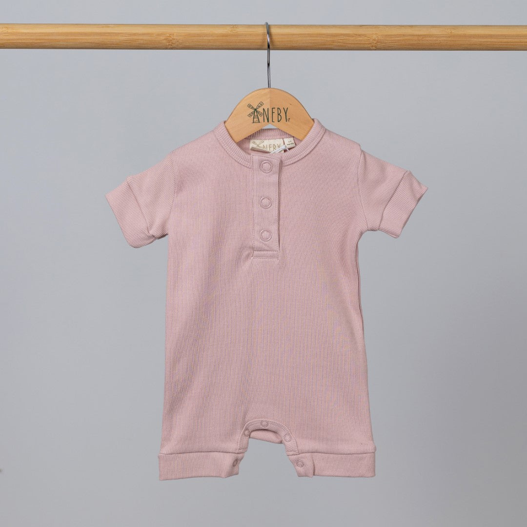 Dusty pink short sleeve rib baby romper hanging, front view.
